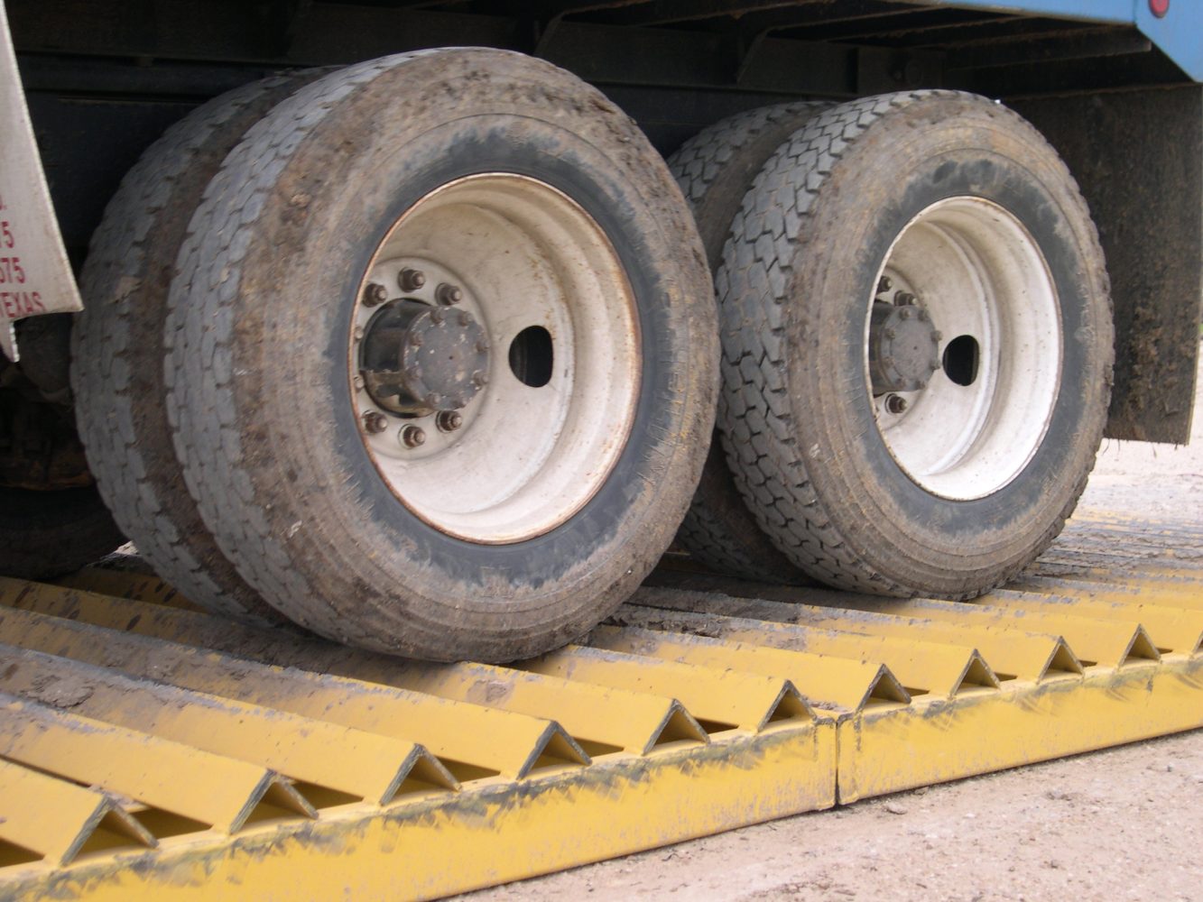 A close up of a trucks wheel driving over a Rumble Grid