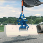 A Kenco Barrier Lifter A concrete barrier being lifted by a Kenco Barrier Lifter