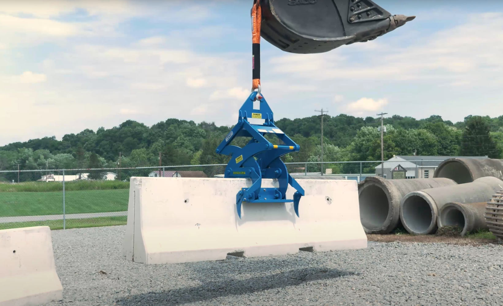A concrete barrier being lifted by a Kenco Barrier Lifter