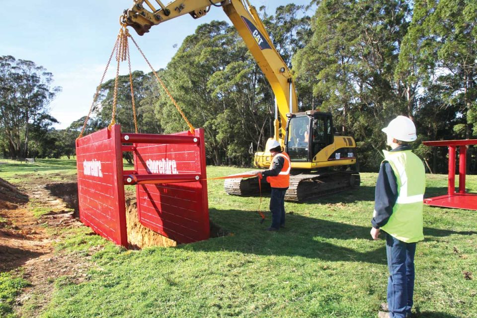 A shoring box being installed into a trench