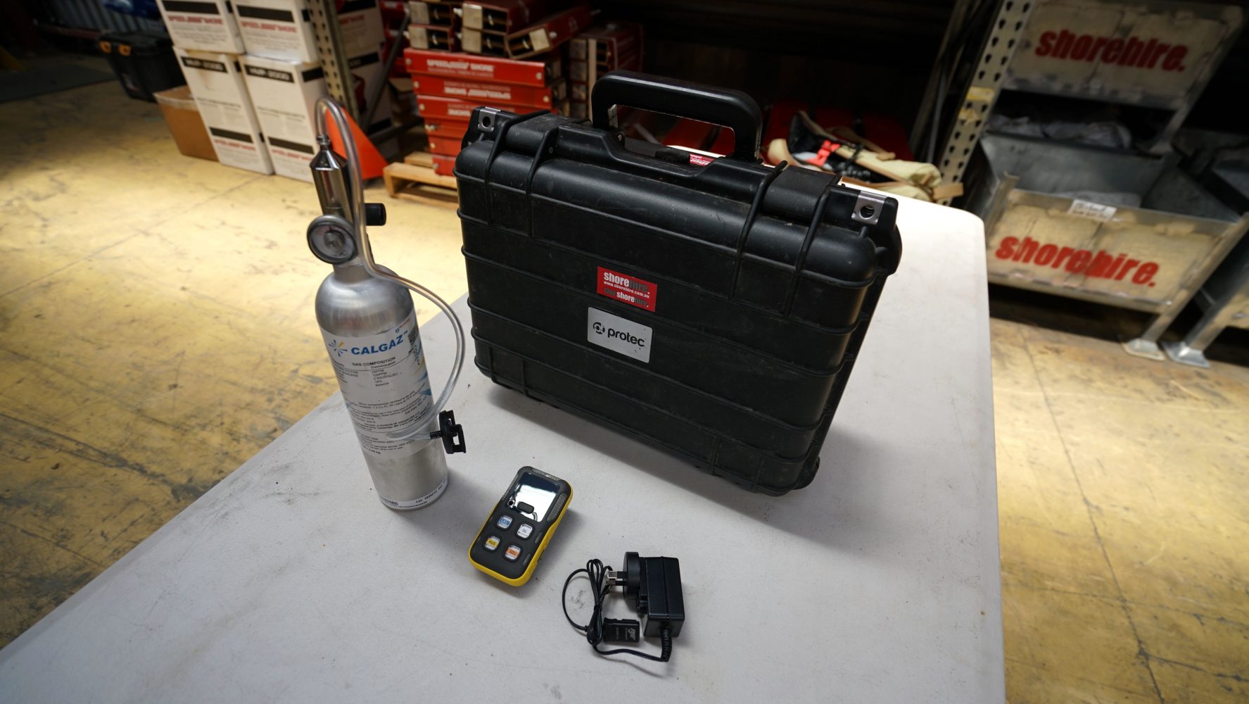 The items within the Confined Space Gas Detector kit laid out on a table