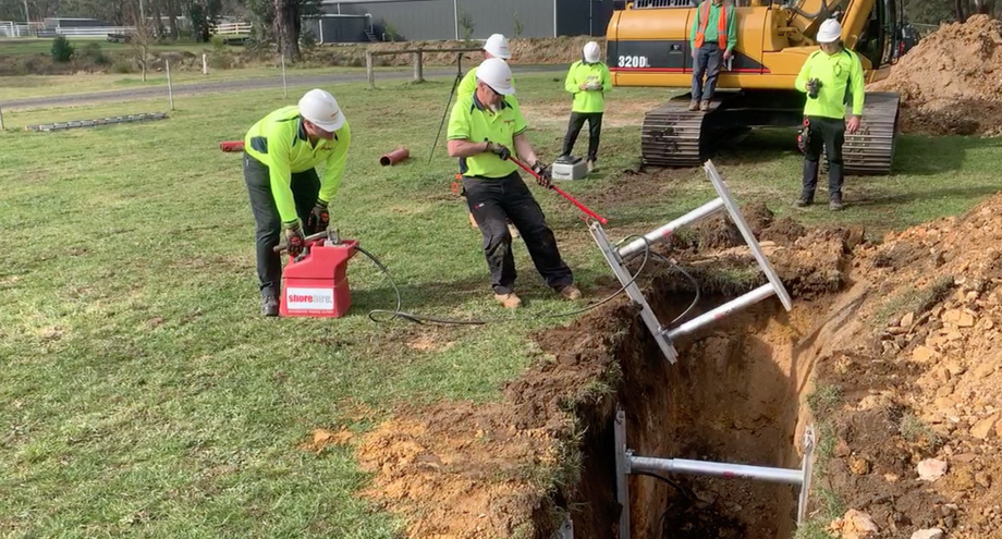 Workers installing Vertishores into a trench